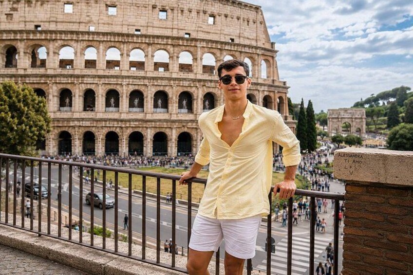 A person standing in front of the Colosseum with a clear view of the ancient Roman amphitheater. 2