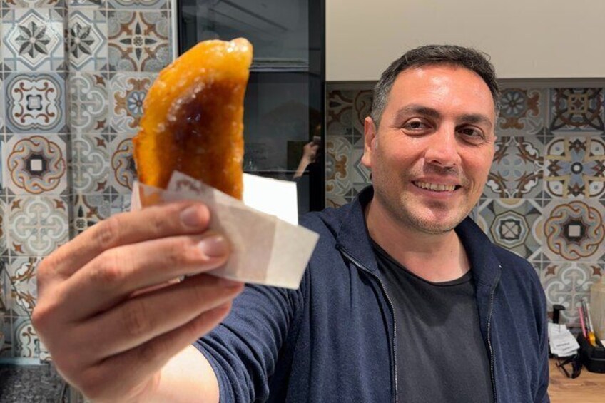 A person holding a glazed donut. 2