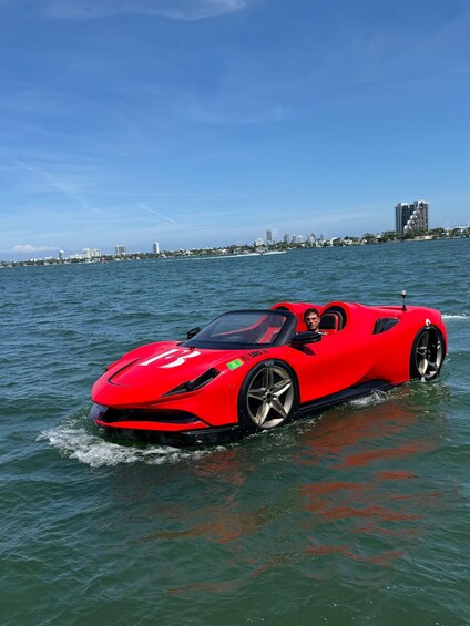 A red sports car driving through water. 2
