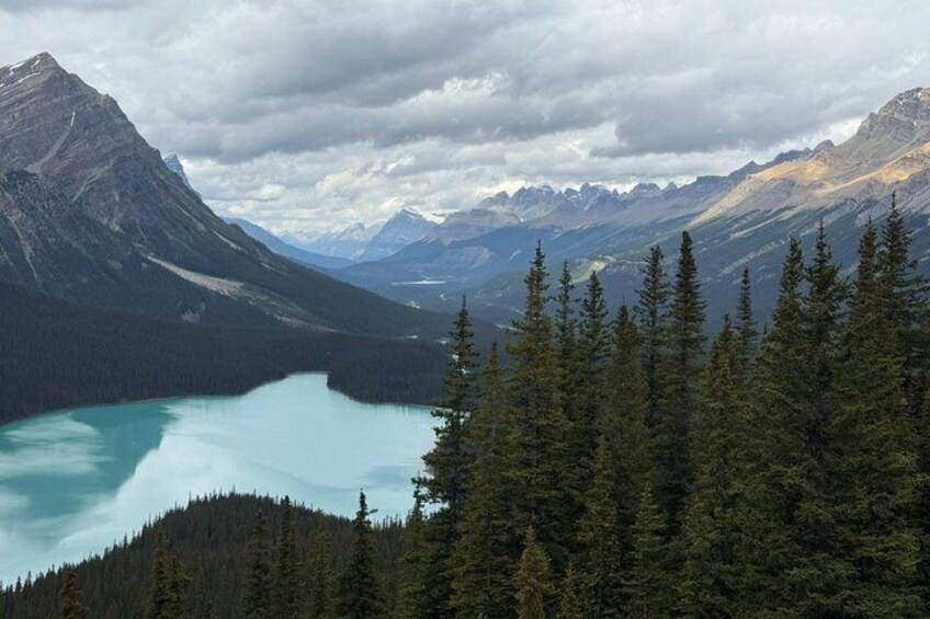 A mountain range, a turquoise lake, and dense forest. 1