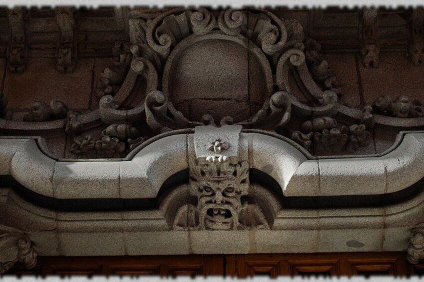 A detailed architectural carving with a central figure and ornate patterns. 2
