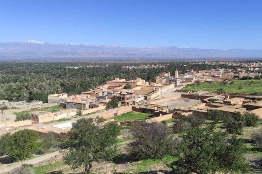 A town with buildings, a mosque, and mountains in the background. 3