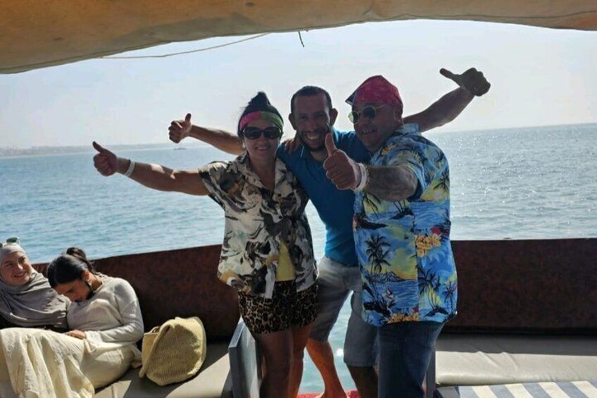 A group of people on a boat with the ocean in the background. 5