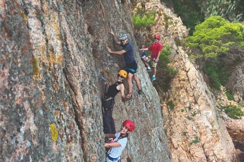 A group of people rock climbing on a steep cliff. 4
