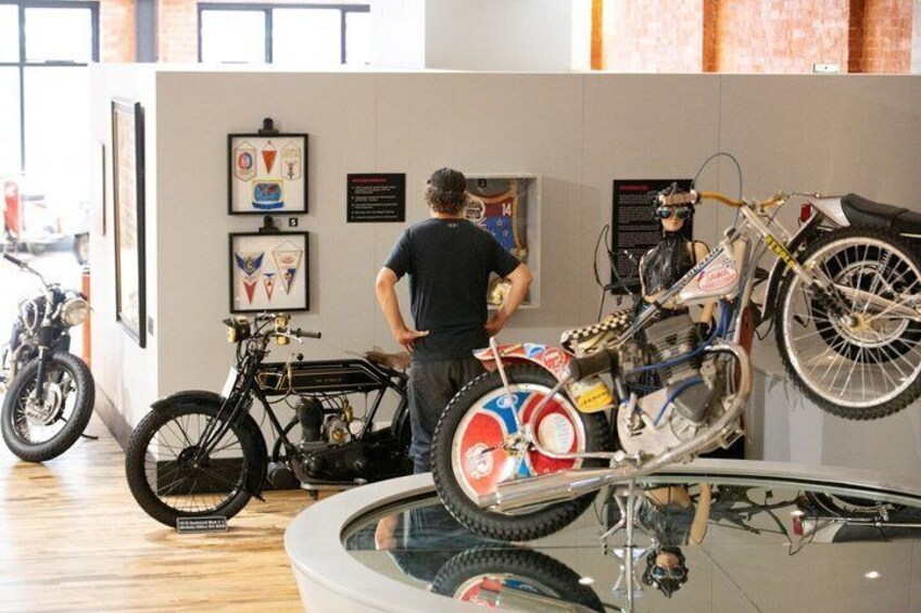 A museum with vintage motorcycles on display. 2