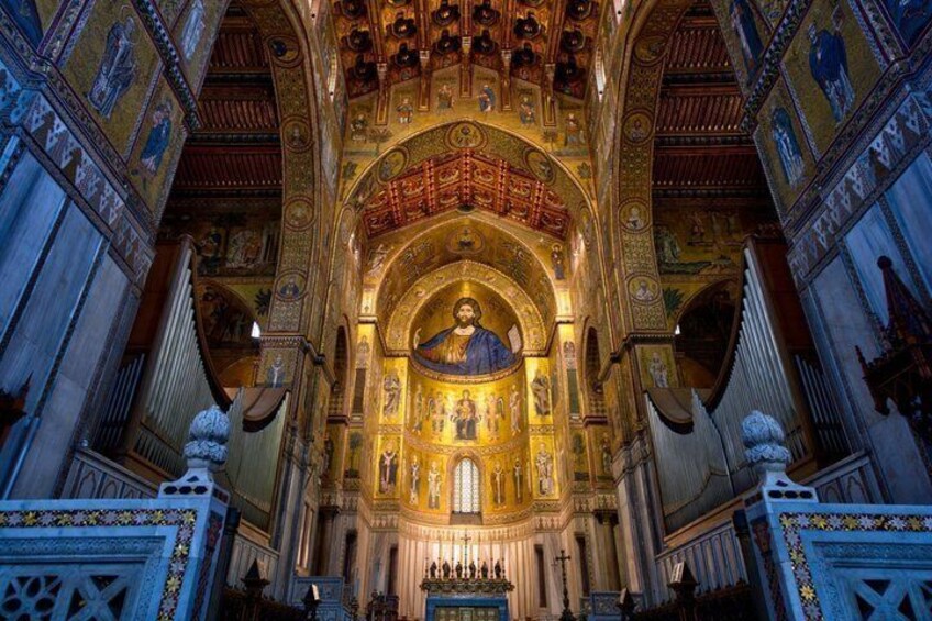 An ornate church interior with a central dome, golden mosaics, and detailed wall decorations. 5