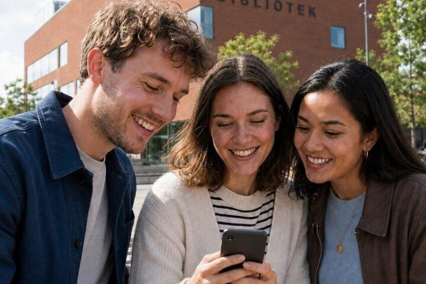 Three people looking at a smartphone, with a building labeled 'BIBLIOTEK' in the background. 4