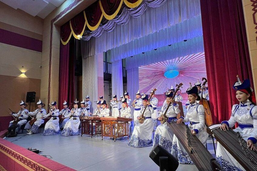 A group of musicians performing on stage with traditional instruments. 4