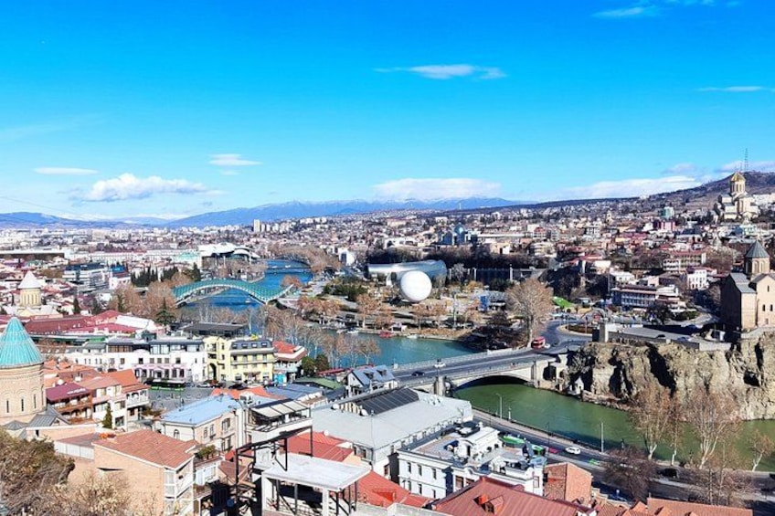 A cityscape with a river, a bridge, and a prominent church. 1