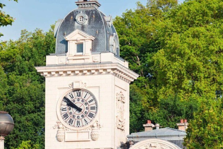 A clock tower with a dome and a large Roman numeral clock face. 2