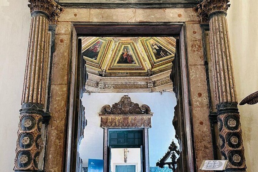 An ornate doorway with intricate carvings and a decorative ceiling. 4
