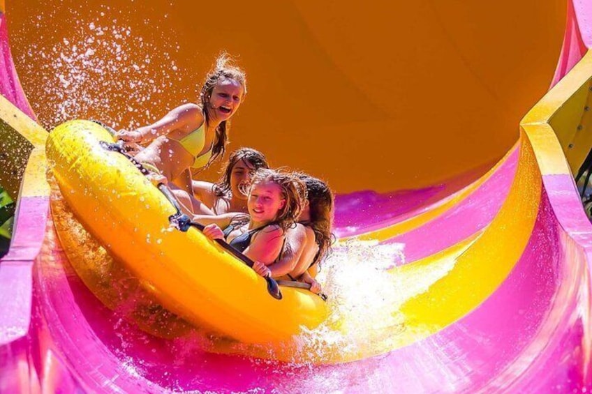 A water slide with a yellow raft and a pink slide. 5