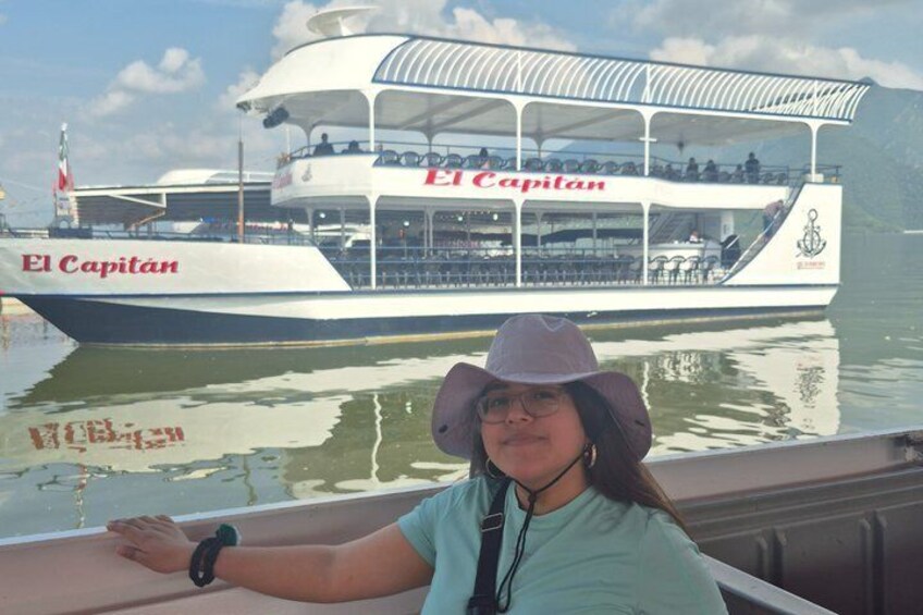 A person on a boat with 'El Capitán' written on the side. 2