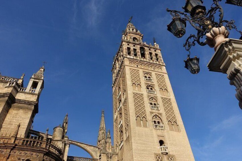 A tall, ornate tower with intricate architectural details and a clear blue sky in the background. 5