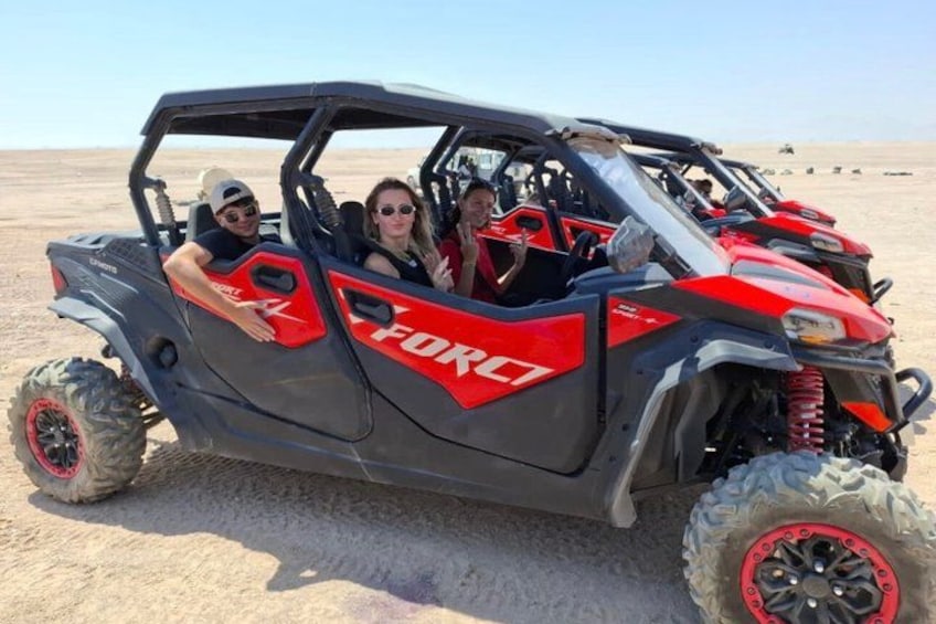 A red and black off-road vehicle with the word 'FORCE' on the side, parked on a sandy terrain. 3