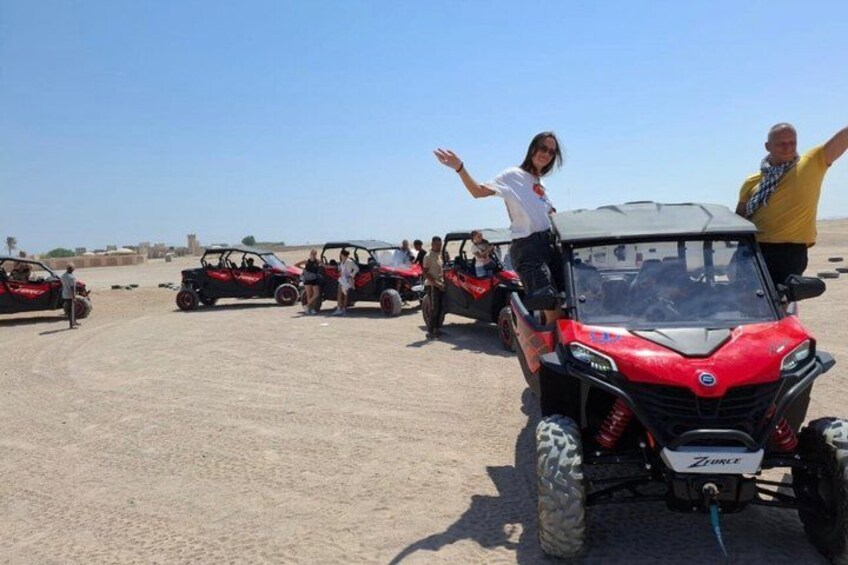 Off-road vehicles parked in a desert setting. 2