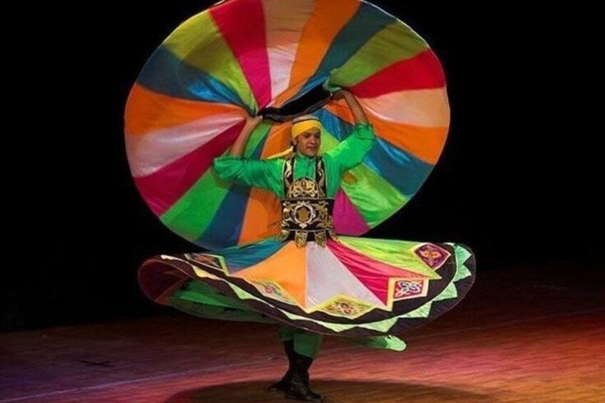 A person performing a dance with a colorful, multi-layered skirt. 5