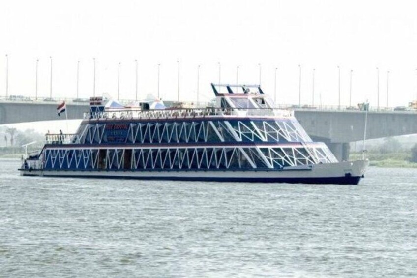 A riverboat with a white hull and blue accents, including a blue stripe and a white superstructure with a blue roof. 1