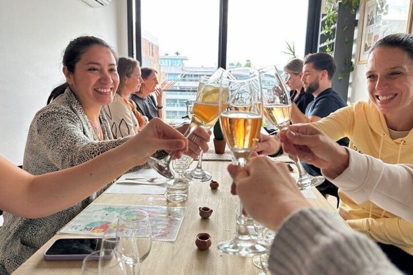 A group of people toasting with glasses of beer at a table. 5