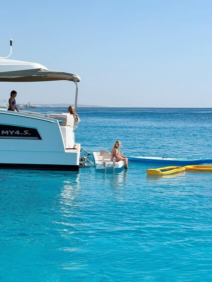 A yacht named MY4.S. anchored in calm blue waters with a clear sky. 5