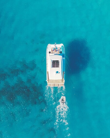 A boat with a cabin and seating area on a turquoise sea. 3