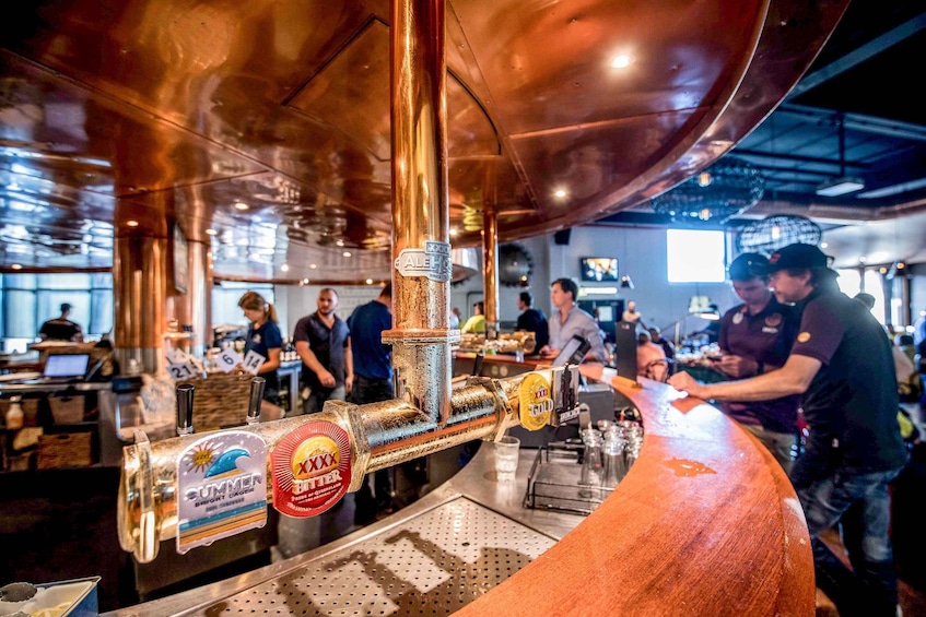 A bar with a copper tap labeled 'SUMMER BRIGHT LAGER' and 'XXX GOLD.' 3