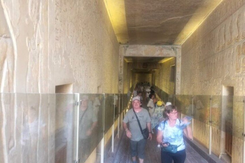 A corridor with stone walls and a glass railing. 5