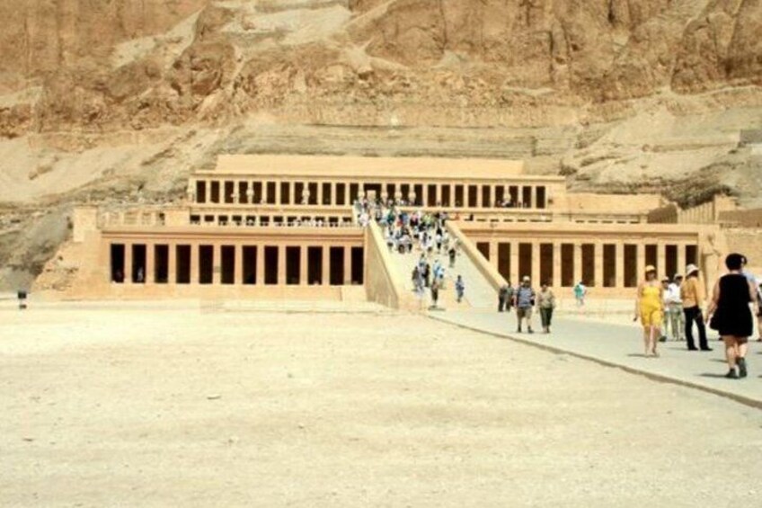A large ancient Egyptian temple complex with a grand staircase leading to the entrance. 1