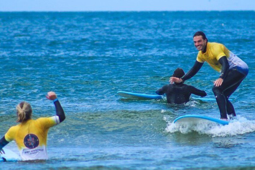 Three people surfing in the ocean. 4