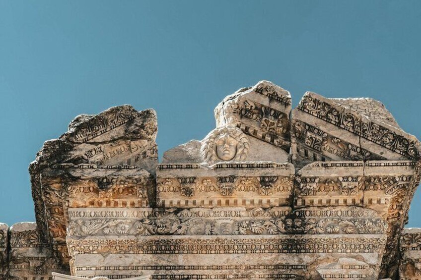 Ancient stone carvings with hieroglyphs on a large rock structure. 4