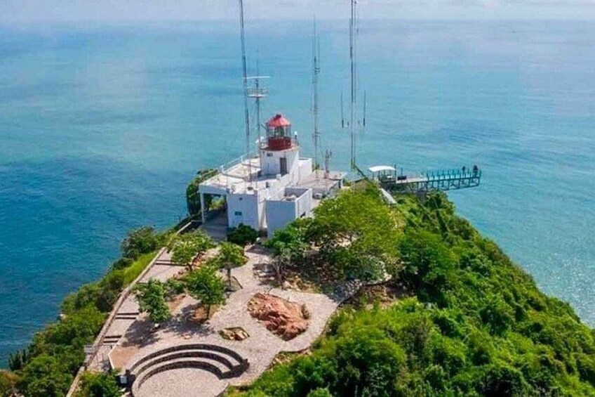 A lighthouse on a cliff with a clear view of the sea. 1