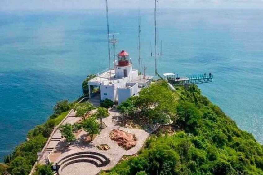 A lighthouse on a cliff with a clear view of the sea. 1