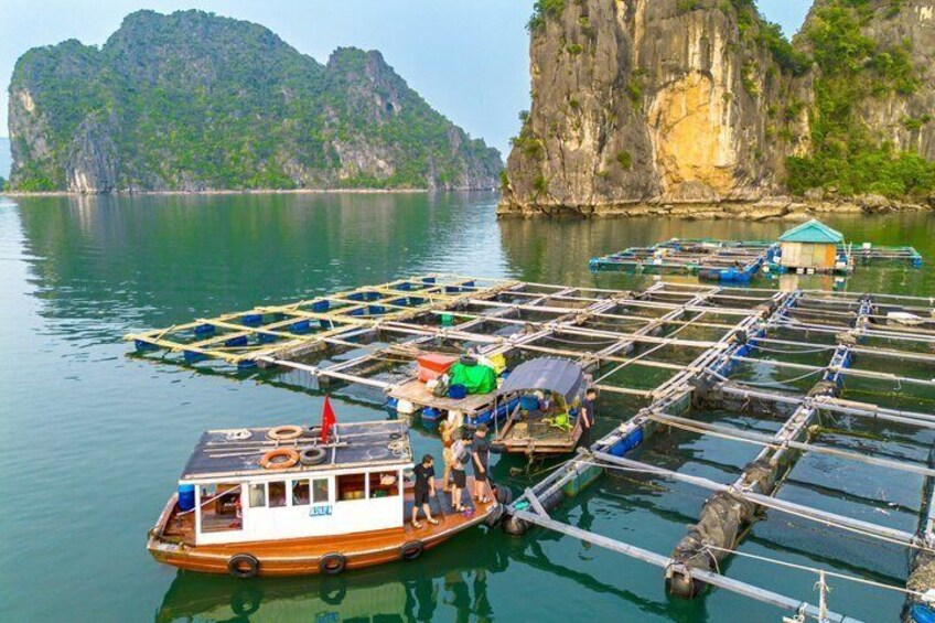A boat docked at a floating dock with a mountainous backdrop. 5