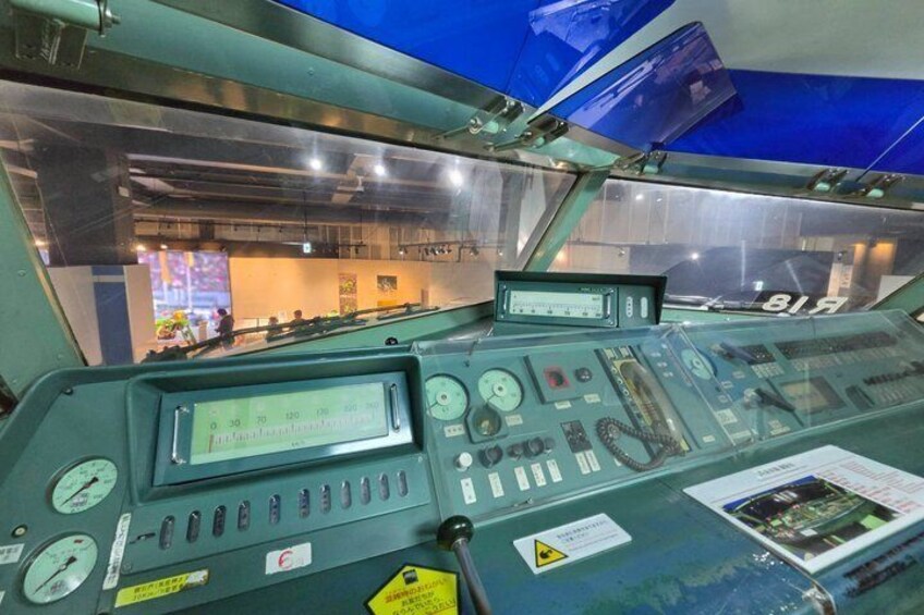 A control room with various dials, gauges, and a digital display. 5