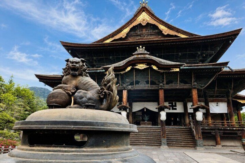 A traditional building with a lion statue in front. 1
