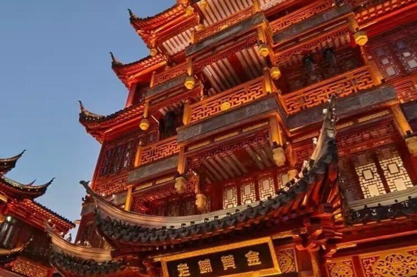 A traditional multi-tiered building with ornate red and gold detailing, featuring curved eaves and intricate patterns. 5