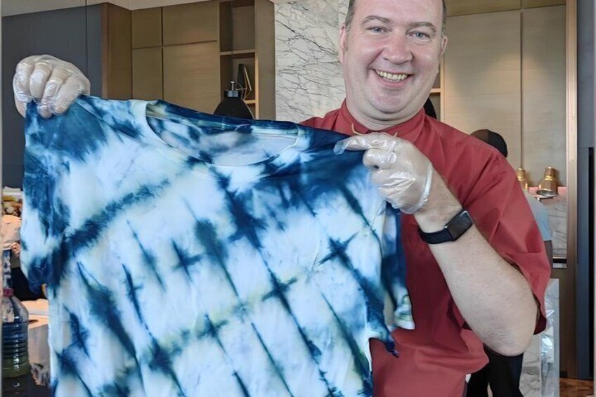 A person holding a tie-dye shirt. 2