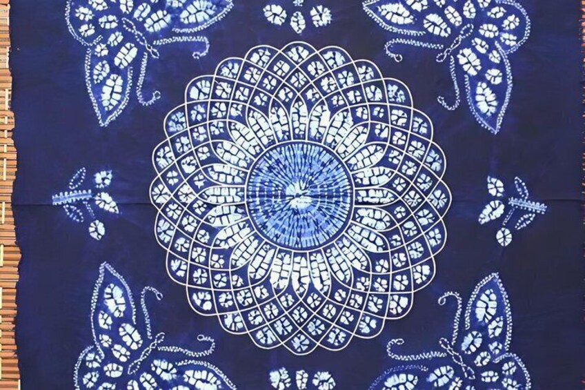 A blue fabric with a white mandala pattern. 5