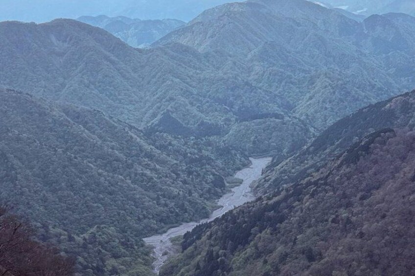 A mountainous landscape with a river flowing through a valley. 2