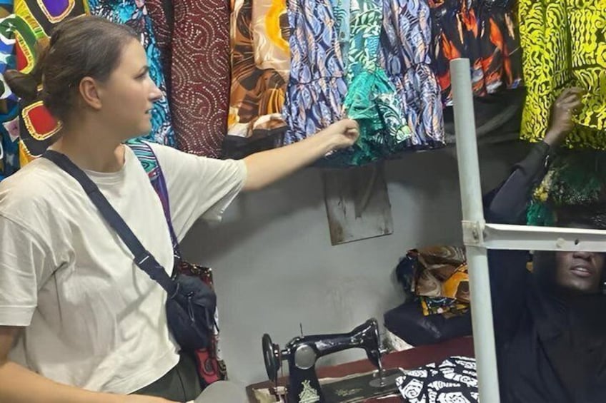 A person examining colorful fabric patterns. 1