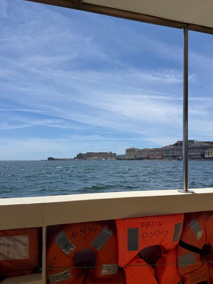 A coastal cityscape with a clear sky, water, and buildings. 5
