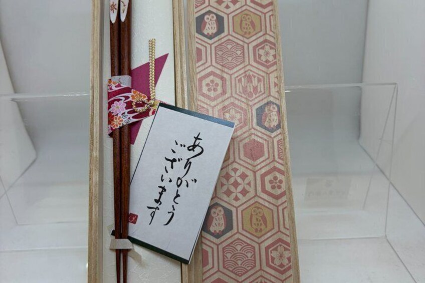 A traditional Japanese room with a patterned curtain, a framed calligraphy piece, and a decorative hanging. 2