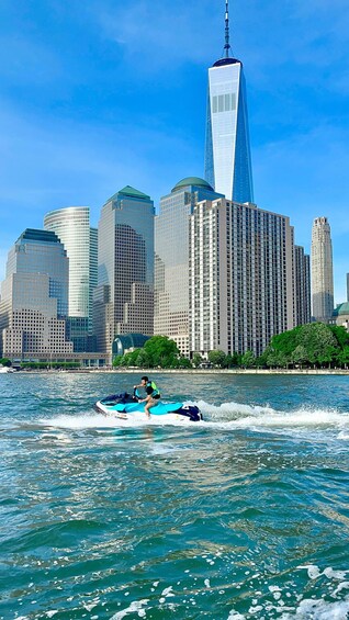 A jet ski on a body of water with a city skyline in the background. 2