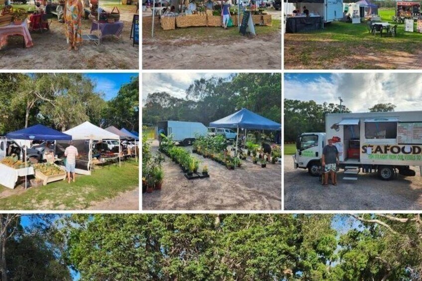 Outdoor market stalls, a truck labeled 'SEAFOOD,' and a forested area. 3