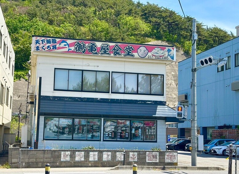 A building with a signboard advertising a seafood restaurant. 5