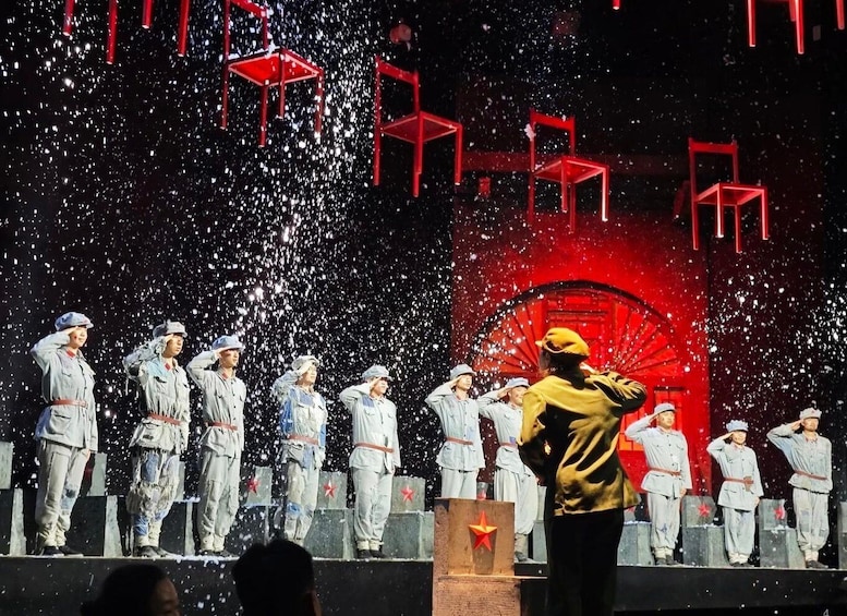 A group of people in uniform saluting, with a red backdrop and falling confetti. 1