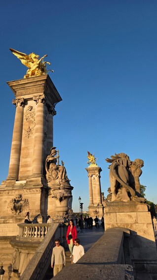 A grand architectural structure with statues and columns, featuring a prominent golden eagle atop a column. 2