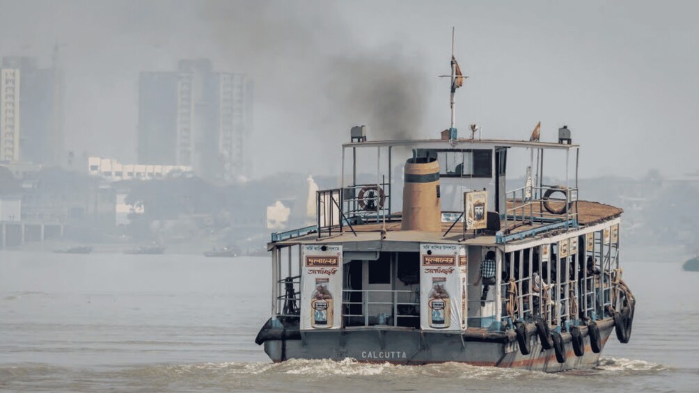A boat named 'CALCUTTA' with a smokestack, a lifebuoy, and advertisements on its side. 4