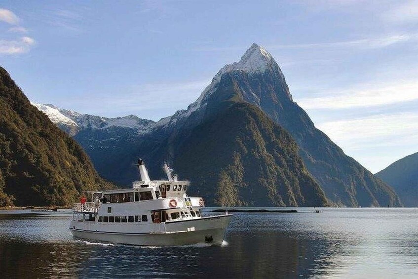 A boat on calm waters with a mountain in the background. 5
