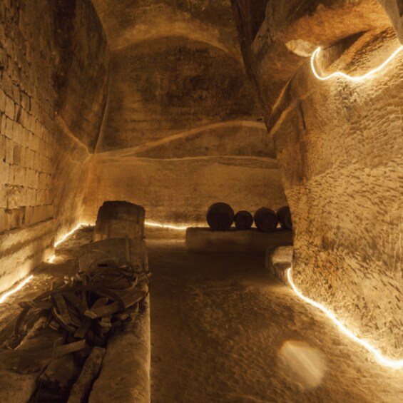 An ice cave with a wooden structure and barrels. 1
